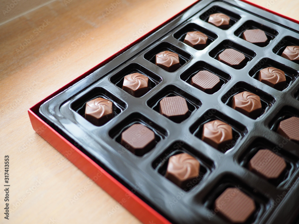 Close up photo of assorted chocolates in a box. Close up photo of assorted chocolates in a box.