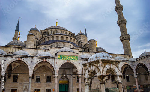 Istanbul, Turkey - CIRCA Nov 2013: Blue Mosque facade. Translation of Arabic writing: Maintain with care the prayers and the middle prayer and stand before God, devoutly obedient. (Al Baqarah 238) photo