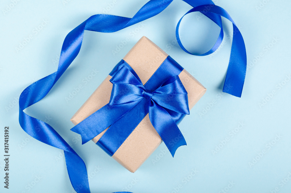 Gift box on blue background composition, present with ribbon and bow. Gift box on blue background composition, present with ribbon and bow.