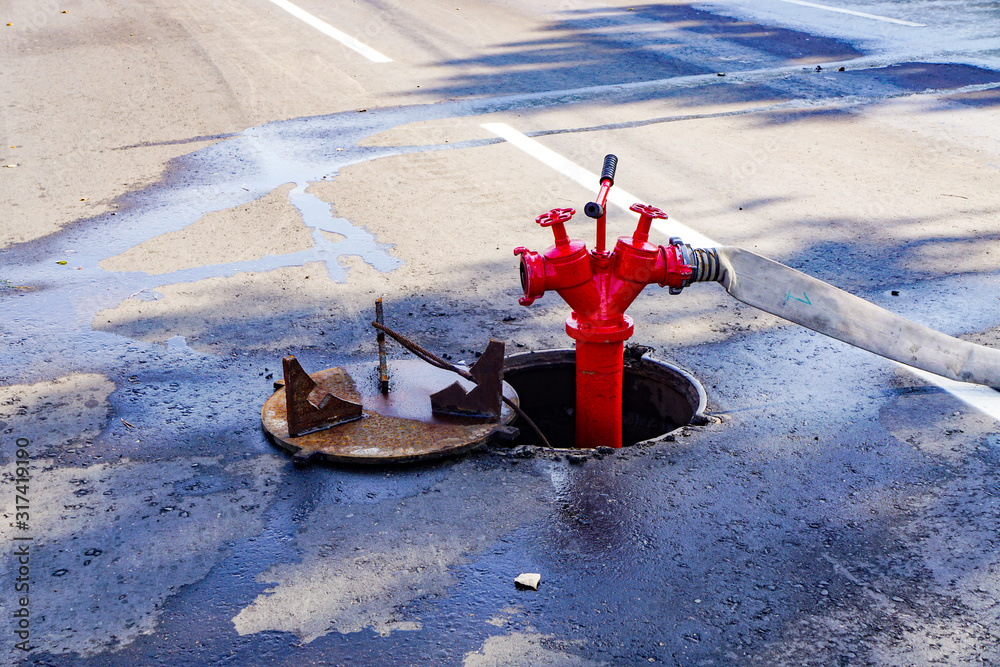 red soviet russian fire hydrant sticking out from under the ground ...