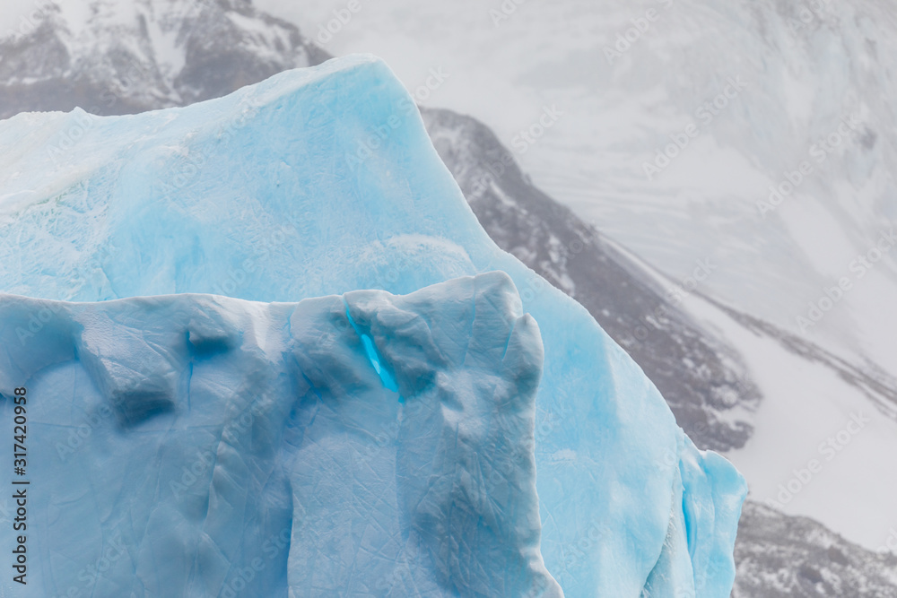 Closeup details of large iceberg floating in the cold water of Antarctica