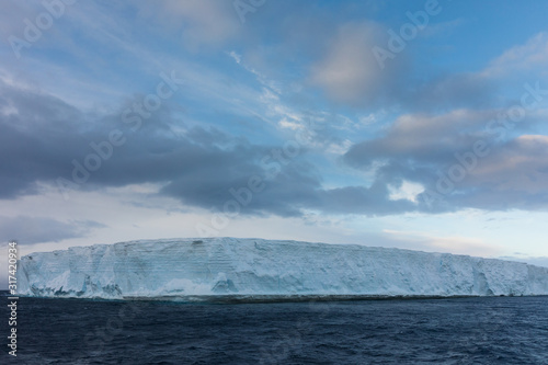 Large tabular iceberg floating in the cold water of Antarctica © Gabi