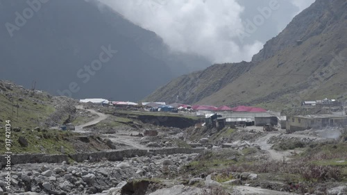 Kedarnath, Uttarakhand, India- View of Kedarnath temple & the surroundings, River Mandakini, damaged/collapsed house( Damaged during Uttarakhand Disaster 2013), new build cottages for pilgrims stay. photo