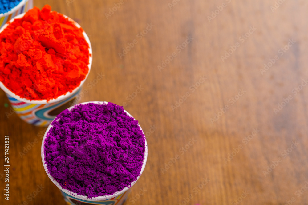 Indian festival Holi concept, colors cup arrange on wooden board Indian festival Holi concept, colors cup arrange on wooden board