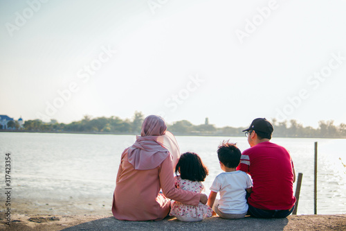 A happy muslim family on a vacation with their son and daughter © Akmalism