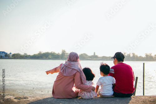 A happy muslim family on a vacation with their son and daughter © Akmalism