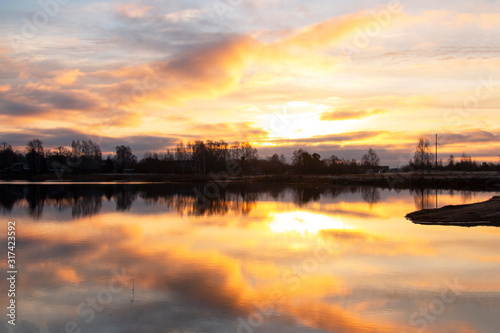 colorful dawn on the lake  clouds reflected in the water