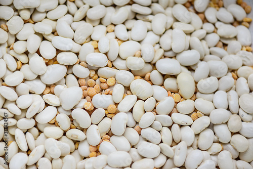 Background of dry white beans and peas. Horizontal orientation, selective focus.