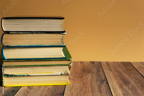 A stack of old books with yellow pages. Book binding. Knowledge and education. Literature in the library..