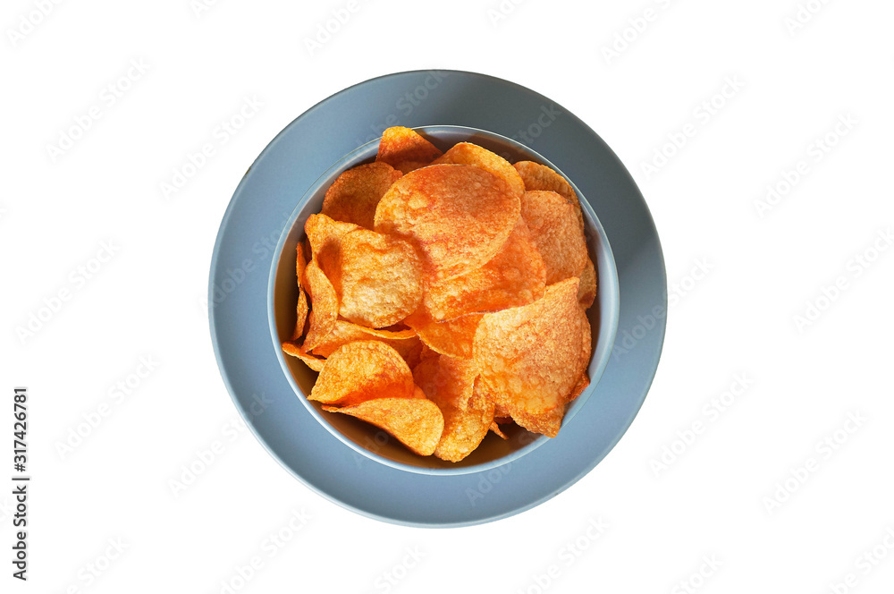 Round ceramic bowl full of spicy fried potato chips isolated lies on plate on white background without shadow. Top view Round ceramic bowl full of spicy fried potato chips isolated lies on plate on white background without shadow. Top view