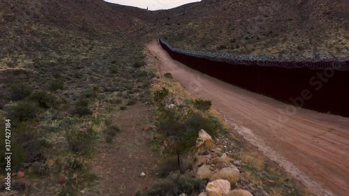 Drone flying along United States and Mexico revealing gap in border fence
