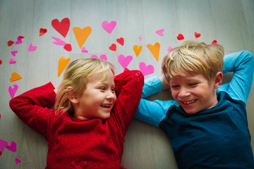 happy cute boy and girl play with hearts from paper, valentine day