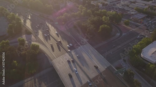 Aerial Drone View 4K of Traffic Cars overlooking Freeway 101 in Woodland Hills California near Thousand Oaks outside of Beautiful Los Angeles California Slow to Stunning Sunset During Rush Hour