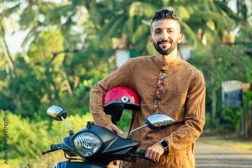 Fototapeta indian man wear helmet and ready to driving explore india attractions of Goa