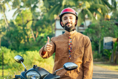 Fototapeta indian man wear helmet and ready to driving explore india attractions of Goa