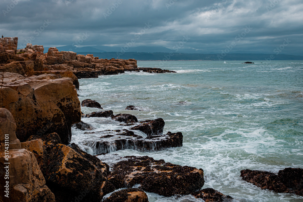 Sea view with rocks, waves breaking on the rocks.