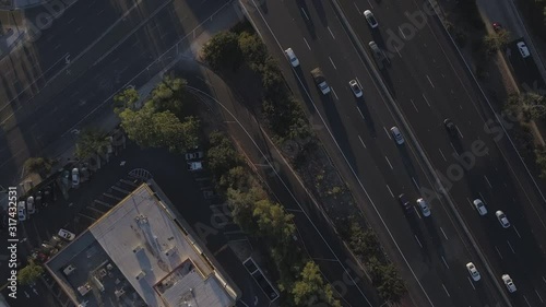 Aerial Drone View 4K of Traffic Cars overlooking Freeway 101 in Woodland Hills California near Thousand Oaks outside of Beautiful Los Angeles California Overhead to Stunning Sunset Mountain View