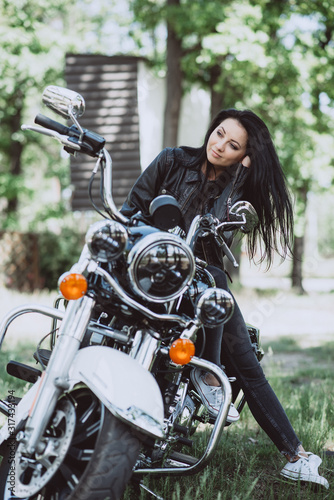 Beautiful sexy womanl with long hair in leather clothes outdoors on a summer day. Soft focus. Biker girl. © Tasha Sinchuk