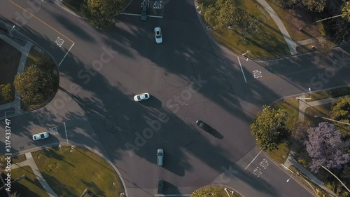 Aerial Spinning Circle Full Birdseye View of Cross Traffic Intersection in Beautiful Beverly Hills California near Los Angeles During Gorgeous Sunset Afternoon Day 4K Drone Overlooking Cars Driving