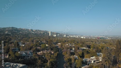 Aerial Slow Hover Shot of Beautiful Beverly Hills California with Green Palm Trees, Hollywood Hills, Mountains in Los Angeles California Sunset Afternoon Day 4K Drone View of Hollywood & Entire Valley