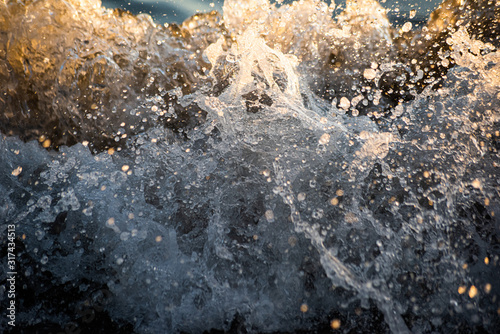 Abstract background with splashes on a pebble beach is close © savelov