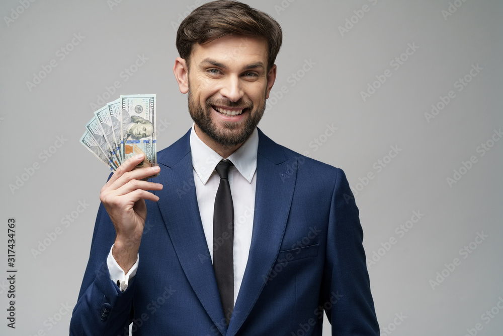young handsome businessman holding US dollar bills