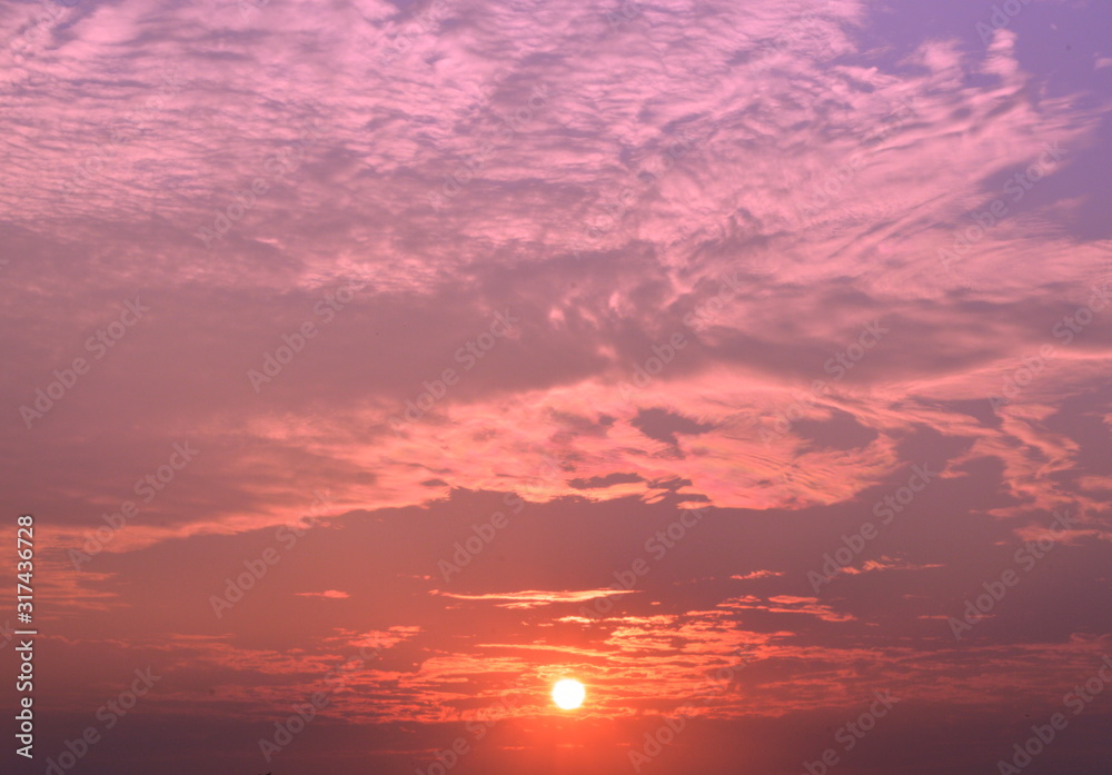 The sky and the light of the sun surrounded by clouds