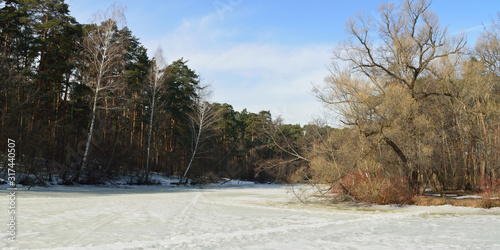 Winter pike fishing on the first ice, beautiful panorama