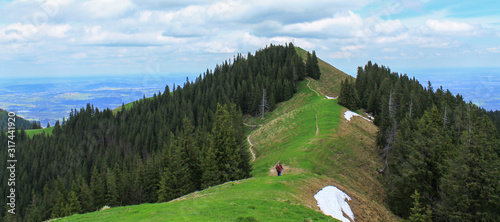 Panorama of Mount Vorderes Hörnle, 1484 m with Summit Cross and Hikers in Ammergauer Alps, in Bad Kohlgrub, Upper Bavaria, Germany photo
