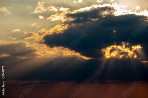 Sunlight penetrating through the clouds © Poowanart