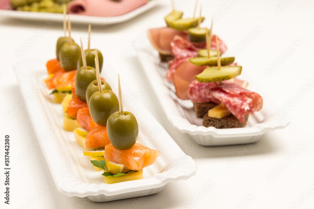 Assortment of canapes with salmon, bacon, cheese, pickles Assortment of canapes with salmon, bacon, cheese, pickles