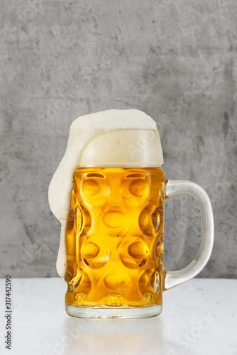 Beer splash in glass on vintage background with copy space