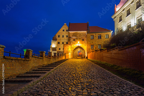Beautiful brick architecture of the Water Gate in Grudziadz at night, Poland