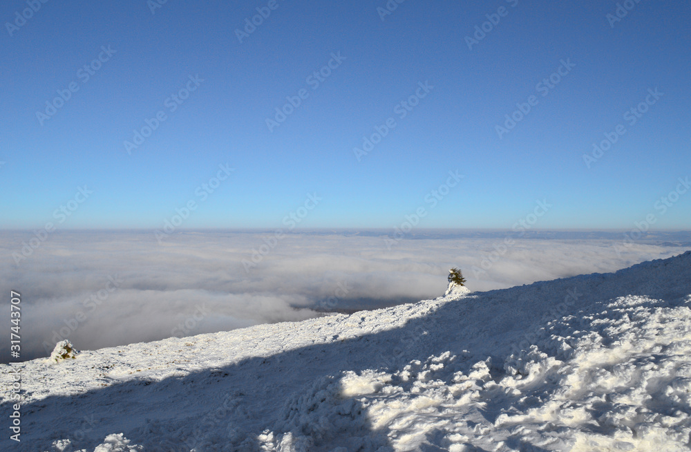 Winter Carpathian mountains on a bright sunny day. Winter snow covered mountain peaks