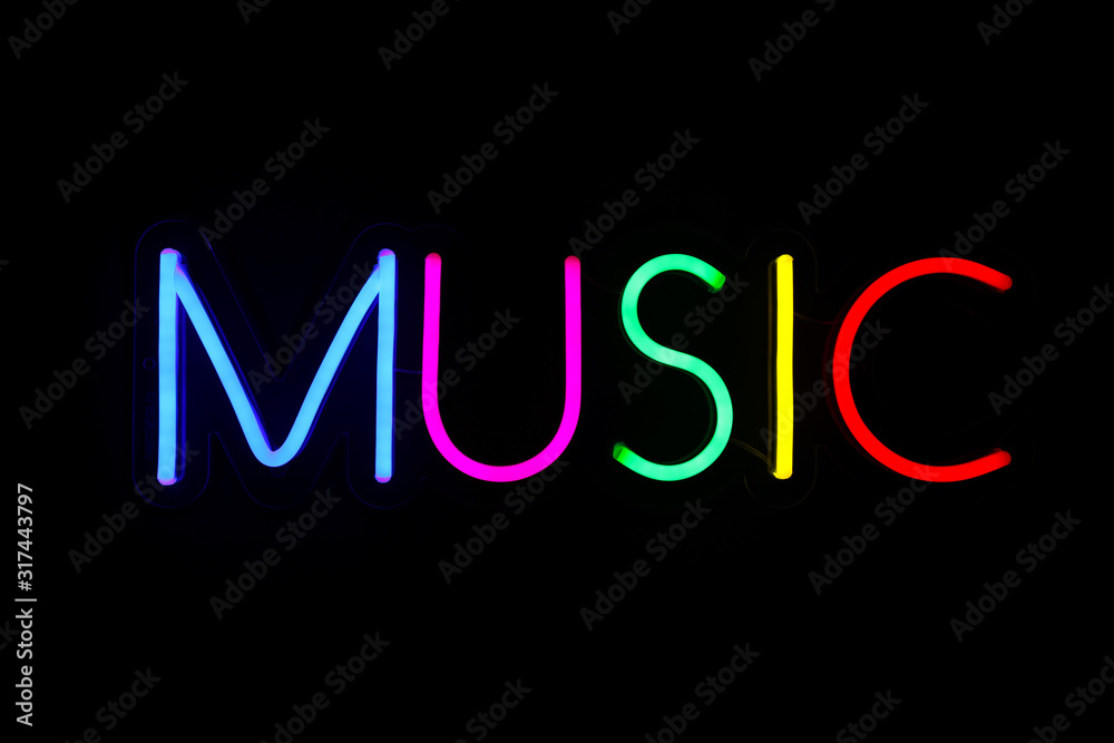Multicolored music sign on isolated black background. Neon concept. Modern style. Neon sign. Flat lay, copy space, top view. 