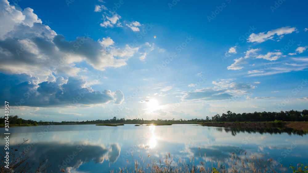 Beautiful sunset landscape with blue sky over lake