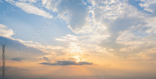 Scenery beautiful sunlight with clouds in the sky.Dramadic landscape blue sky and orange light from the sun through the clouds. photo