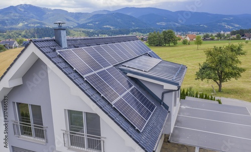 High angle shot of a private house situated in a valley with solar panels on the roof
