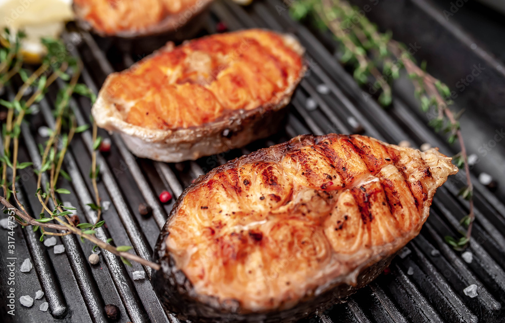 Grilled salmon steak with in a grill pan with spices