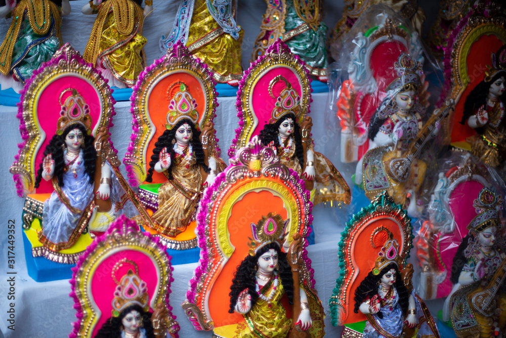 Clay idols of Hindu Goddess Saraswati being made and displayed for the Indian Bengali festival in winter in Bengal. Indian culture and religion. Clay idols of Hindu Goddess Saraswati being made and displayed for the Indian Bengali festival in winter in Bengal. Indian culture and religion.