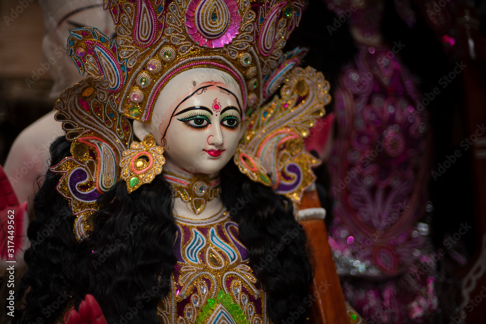 Clay idols of Hindu Goddess Saraswati being made and displayed for the Indian Bengali festival in winter in Bengal. Indian culture and religion. Clay idols of Hindu Goddess Saraswati being made and displayed for the Indian Bengali festival in winter in Bengal. Indian culture and religion.
