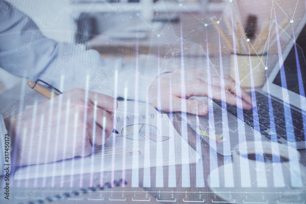 Multi exposure of stock market graph with man working on laptop on background. Concept of financial analysis. Multi exposure of stock market graph with man working on laptop on background. Concept of financial analysis.