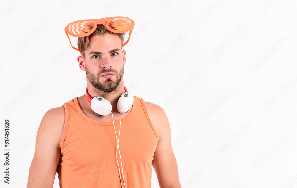 Summer music chart. Handsome man with headphones and sunglasses. Guy unshaven face listening summer music. Party concept. Dj boy. Popular summer track list. Technology and entertainment. Modern life