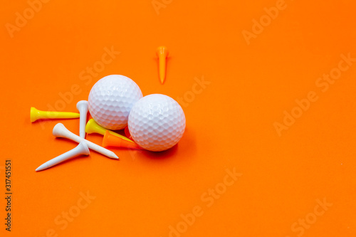 golf ball land tee are on orange background