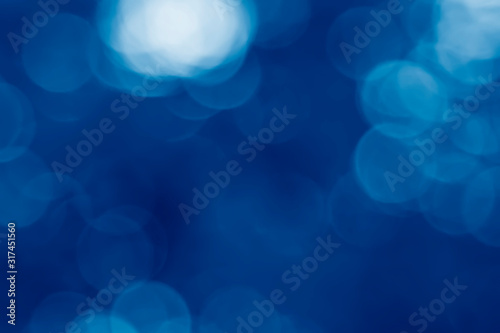 image of summer blur background toned in trendy Classic Blue color of the Year 2020