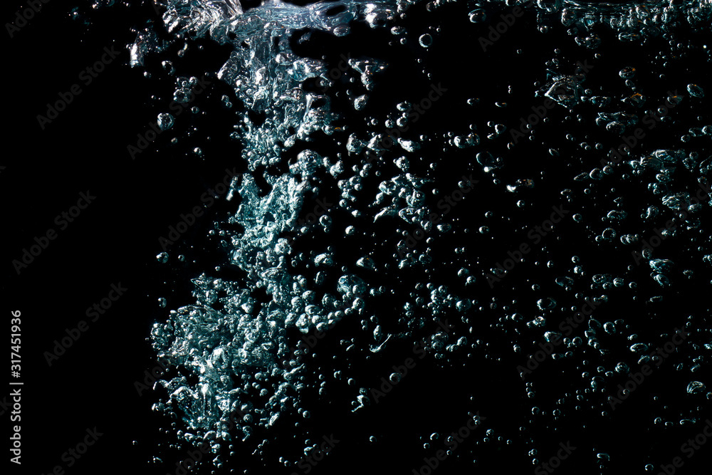 water waves with beautiful bubbles on a black background.