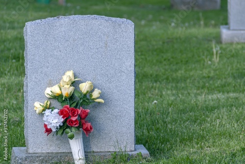 Put on a concrete grave surrounded by green grass