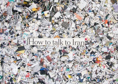 Newspaper confetti from above with the words How ti talk to Iran