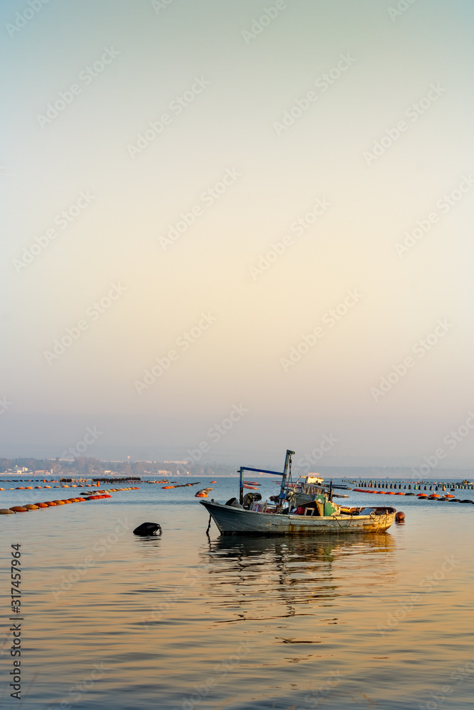 Obraz premium Small Boat Moored in Vicinity of Mussil Plantation In Italy