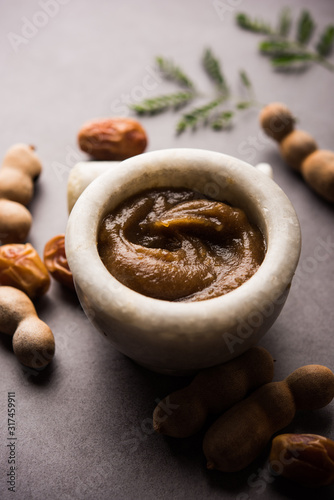 Dates Tamarind Chutney - Khajoor crushed to paste and mixed with Imli or imalee paste, served as a side dish in India photo